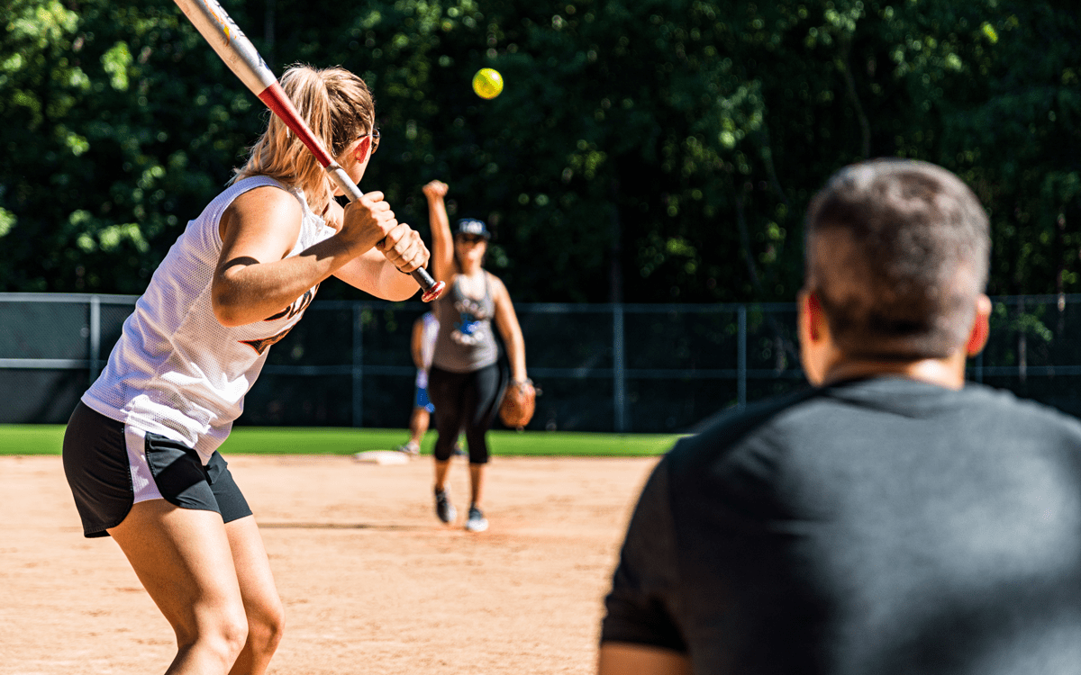 Softball Coach throwing ball at player/student. If injury occurs, you as an educator could be liable